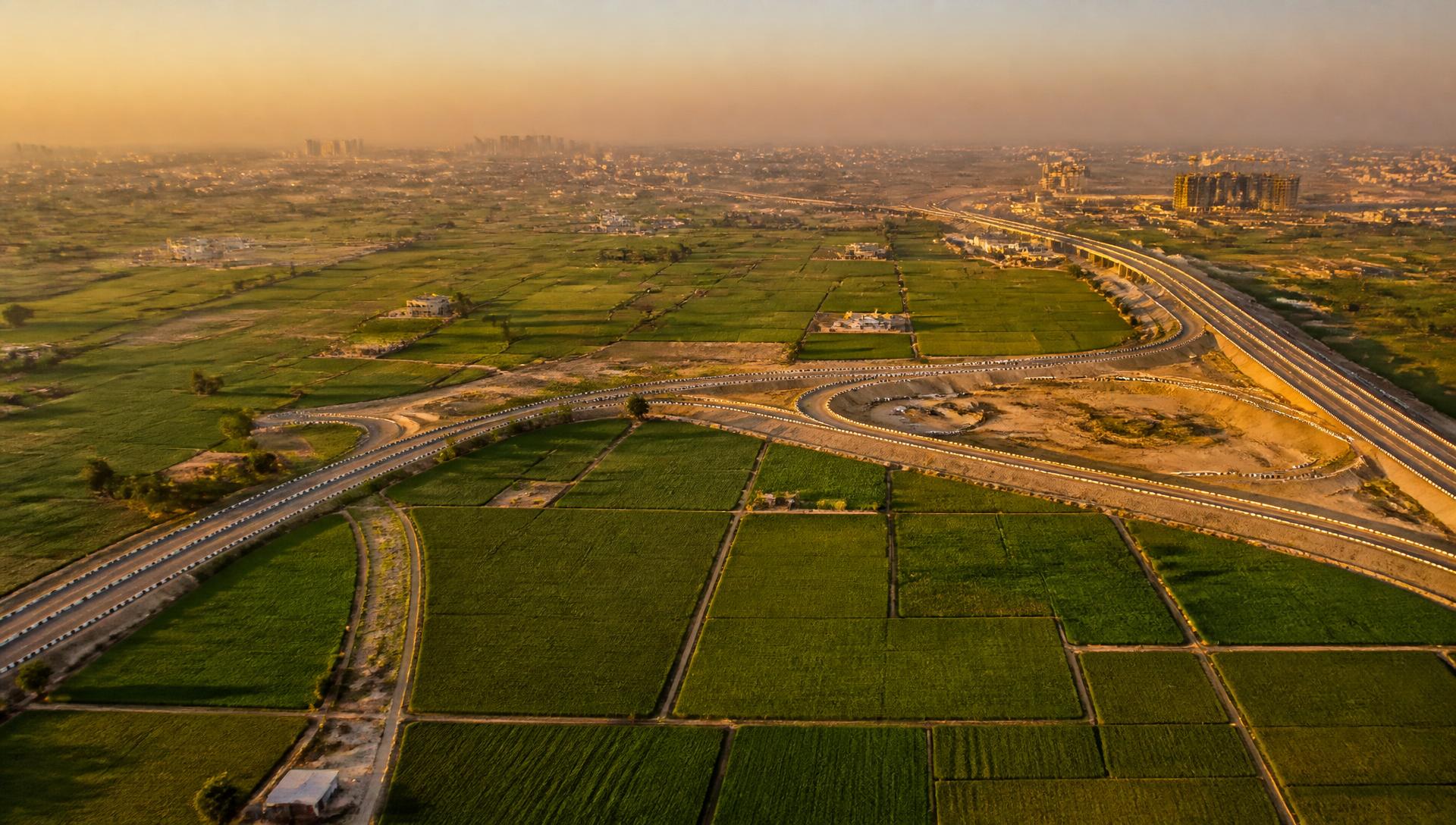 Aerial view of land parcels beside a new expressway junction near Lucknow